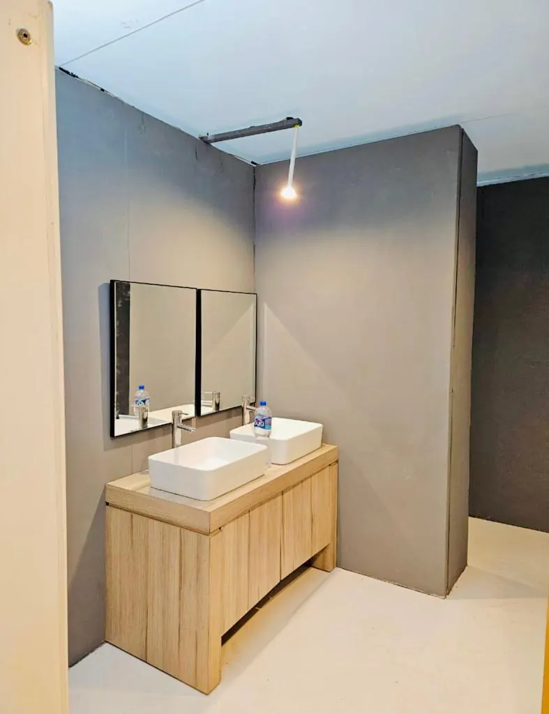Lavabo doble con mueble de madera y espejo en un baño portátil de lujo VIP
